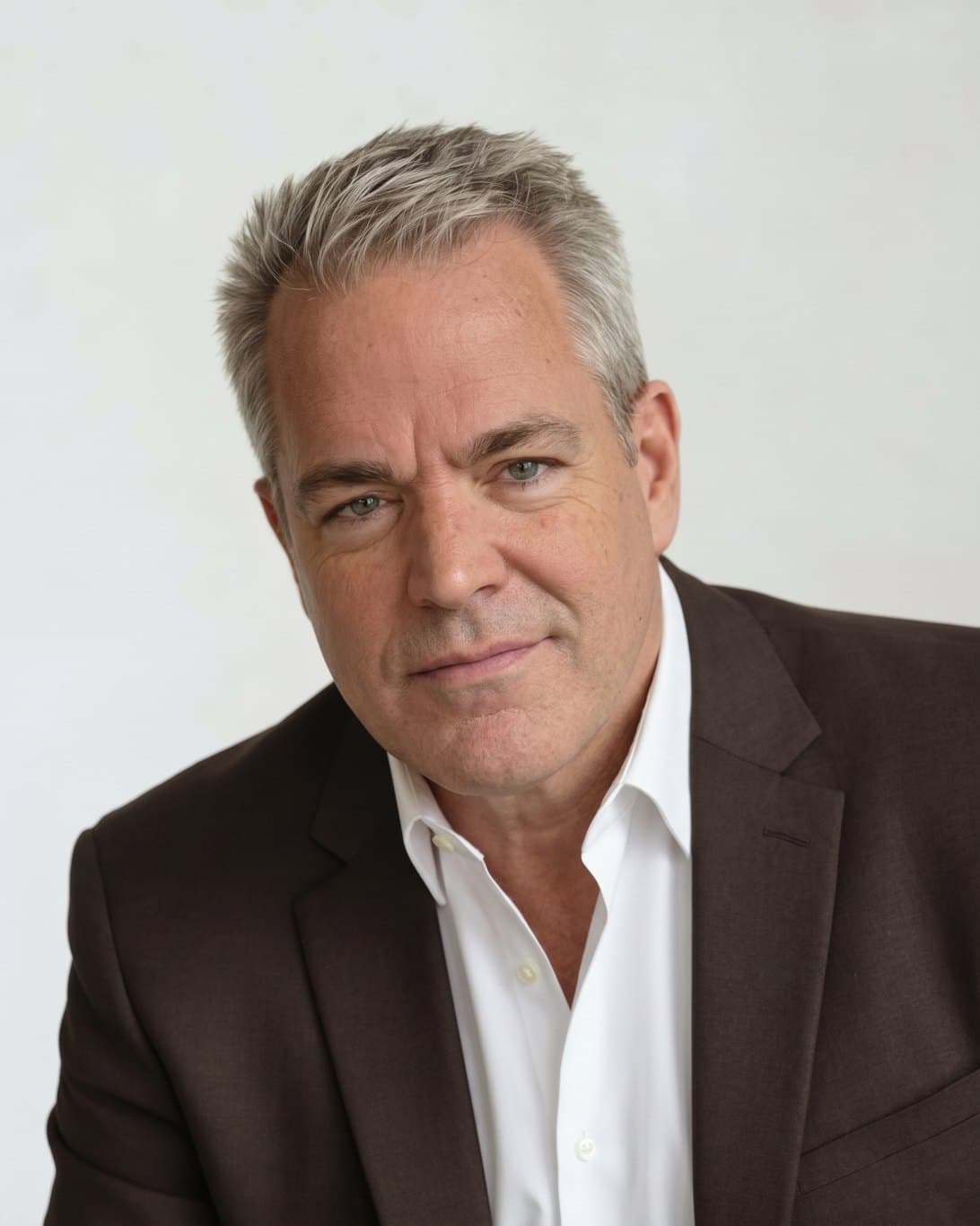 Portrait of comedian Mike James in a dark blazer and white open-collar shirt
